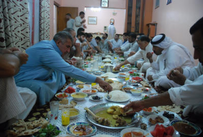 Eating the Iftar meal with my friends.  The food is excellent.