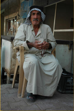 Old man on the street side of Dholoiya