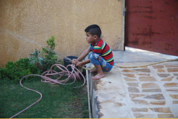 Abud playing with water hose