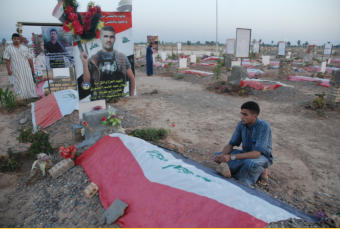 One of the fighters grieves for his good friend who was killed in the battle for Dholoyia.