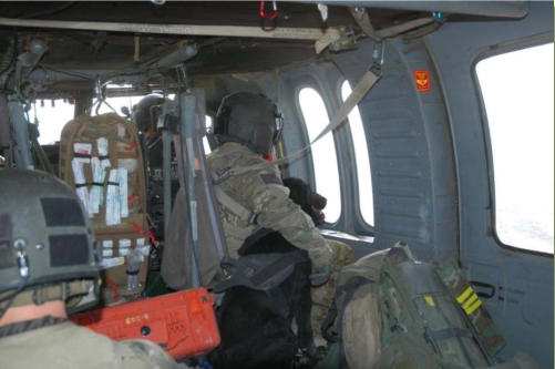 military working dog snuggles up to crew chief on flight to medical attention