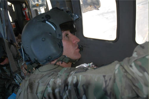 Sgt Zachary Menzies looks at medical equiptment in helicopter as he works on patient on medevac helicopter working in Afghanistan.