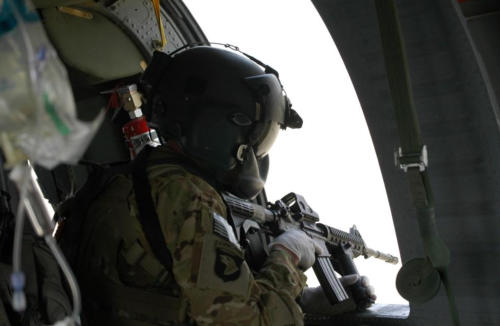 SSGT Jason Bowen is seen peering out window of medevac helicopter just prior to landing at LZ