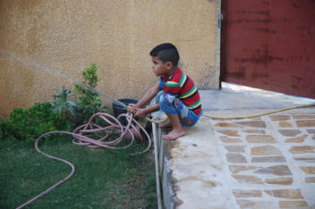 Abud playing with water hose