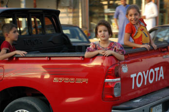 Retrieved photo.  Kids in bed of truck.